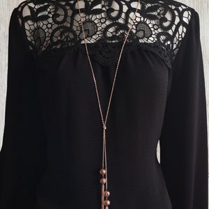 34&quot; long Rose gold tone knotted lariat style necklace with natural lava beads & chain tassel detail