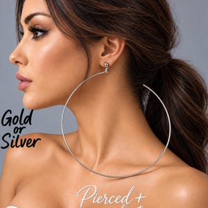 May include: A large, thin, circular silver hoop earring with a ball-style post attachment. The image includes the text Gold or Silver and Pierced + non pierced options, indicating available metal finishes and attachment styles for the jewelry.