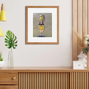 May include: A framed illustration of a young person wearing a yellow and black swimsuit with a yellow bird perched on their head. The background is a light blue and gray watercolor wash.