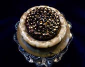 A Georgous Bronze Twinkle Button Sets Atop a Carved Celluloid Fastener Above a Beautiful Tall Glass Column Salt Cellar
