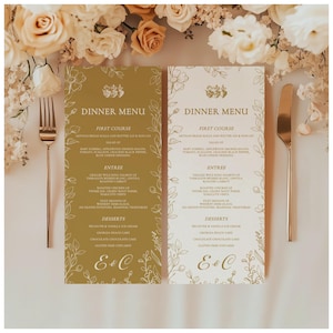 May include: Two wedding dinner menus with floral designs and the text "Dinner Menu." The menus are in gold and white, with a gold fork and knife on either side. The menus list the courses and the initials "E&C."