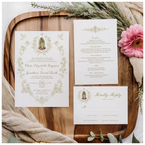 May include: Wedding invitation suite featuring a main invitation, reception details, and a reply card. The design includes gold floral accents, a religious icon, and the names Claire Elizabeth Ferguson and Jonathan David Smith. The suite is on a wooden tray.