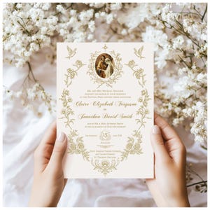 May include: An ivory wedding invitation with gold floral and dove accents. The invitation features the names "Claire Elizabeth Ferguson" and "Jonathan David Smith" with event details. The design includes a central image and decorative borders.