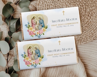 May include: Two white chocolate bar wrappers with a blue watercolor background. The wrappers feature a religious image of a girl and boy in blue and gold robes. The text on the wrappers reads "Anna-Maria Huberton First Holy Communion Sunday, May 26, 2025".