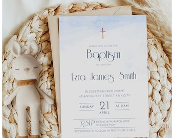 May include: A light blue baptism invitation with a watercolor background and gold glitter. The invitation reads "Kindly join us for the Baptism of our son Ezra James Smith" and includes the date, time, and location of the event. RSVP information is also included.