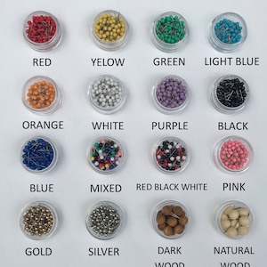 May include: Assortment of push pins in various colors, including red, yellow, green, light blue, orange, white, purple, black, blue, mixed, red black white, pink, gold, silver, dark wood, and natural wood.