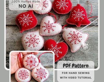 May include: A collection of felt Christmas ornaments in red and white, featuring embroidered snowflake patterns. Shapes include hearts, bells, and round baubles with hanging ribbons. Text includes 100% Human made NO AI and PDF Pattern for hand sewing with video tutorial.