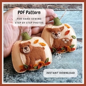 May include: Two felt pumpkin decorations with woodland animal designs. One features a bear, the other a deer and fawn. Each has a green stem, autumn leaves, and a string for hanging. The text "PDF Pattern" and "Instant Download" are visible.