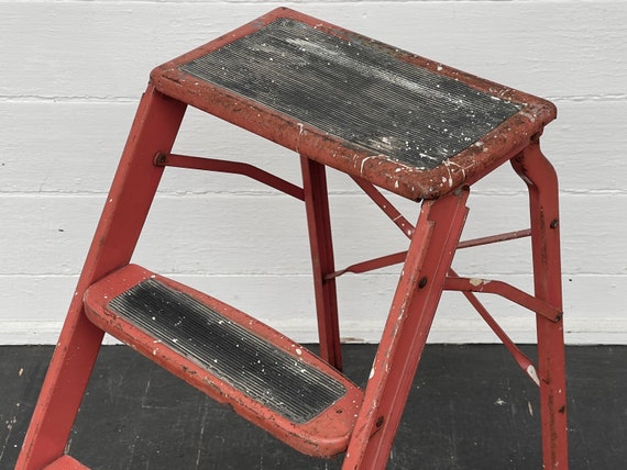 red metal garden stool