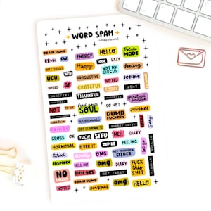 May include: A rectangular sticker sheet titled WORD SPAM by magpiesoul featuring numerous small, colorful adhesive labels with various phrases and words in different fonts, colors, and styles, interspersed with small black star symbols throughout.