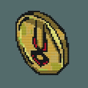 Puede incluir: Una moneda de oro pixelada con un diseño rojo y negro. La moneda tiene una cara con una amplia sonrisa y un ojo negro.