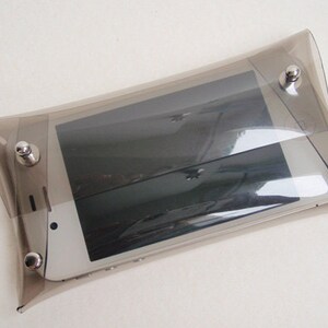 May include: A clear plastic phone case with silver metal accents. The case is designed to protect a smartphone.