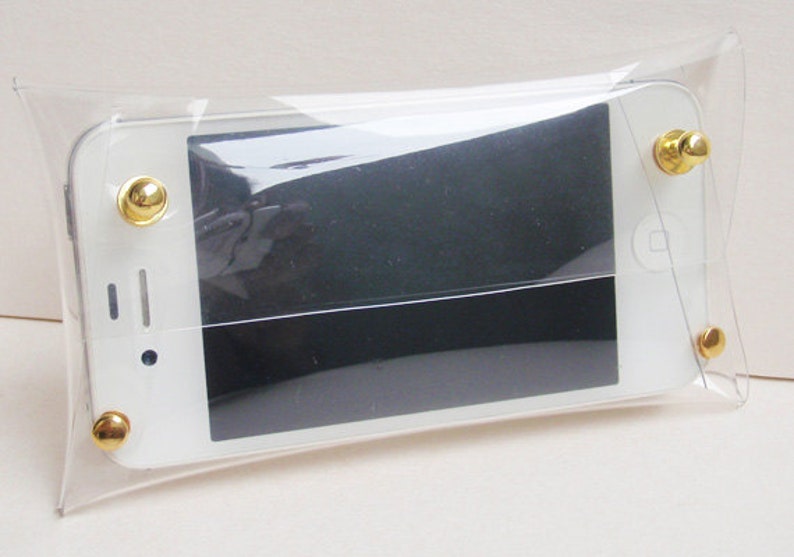 May include: A clear plastic phone case with gold accents. The case is designed to protect a smartphone.