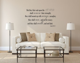 May include: A white couch with two throw pillows sits in front of a beige wall with a black vinyl decal of a bible verse from Isaiah 40:31. The verse reads "But they that wait upon the LORD shall renew their strength; they shall mount up with wings as eagles; they shall run, and not be weary; and they shall walk; and not faint. Isaiah 40:31".