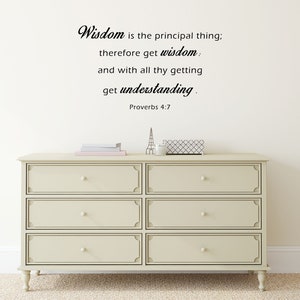 May include: A white dresser with six drawers and a black quote on the wall above it that reads "Wisdom is the principal thing; therefore get wisdom: and with all thy getting get understanding. Proverbs 4:7"
