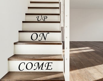 May include: White wooden staircase with the words "COME ON UP" written on the steps in black lettering.