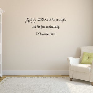 May include: A white wall with a black vinyl wall decal featuring a bible verse: "Seek the LORD and his strength, seek his face continually. I Chronicles 16-11". The wall is in a room with a white bookshelf and a white armchair with a green pillow.