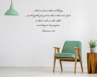 May include: A room with a mint green chair, a wooden side table, and a potted plant. The wall features a quote from Romans 8:28 in elegant script: "And we know that all things work together for good..."