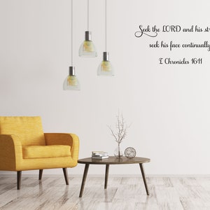 May include: A living room interior with a yellow armchair, a coffee table, and a wall decal with the Bible verse "Seek the LORD and his strength, seek his face continually. I Chronicles 16-11."