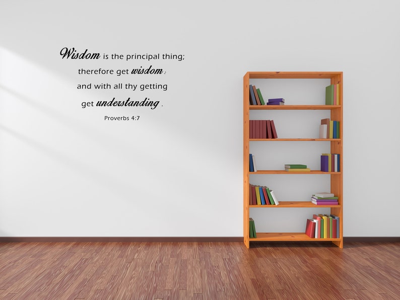 May include: A white wall with a wooden bookshelf filled with books. The wall has a black text quote that reads "Wisdom is the principal thing; therefore get wisdom and with all thy getting get understanding. Proverbs 4:7"