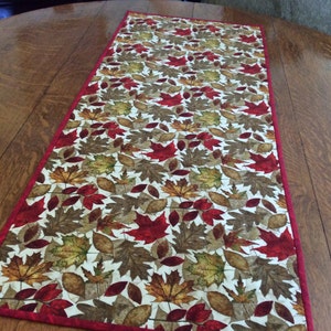 42" x 17 1/2" autumn table runner with red and brown leaves
