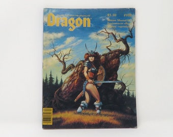 May include: Dragon Magazine issue #100, featuring a cover illustration of a female warrior with a sword and shield, standing in a forest setting. The magazine cover is blue, green, and brown.