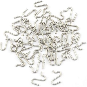 May include: A large quantity of silver-toned metal S-shaped hooks. The hooks are all the same size and shape, and they are arranged in a random pattern.