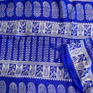 May include: Blue fabric with a white block print pattern. The pattern features paisley shapes, fish, and leaves.