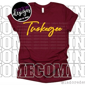 May include: A maroon t-shirt with the text "Tuskegee Homecoming" in yellow lettering.