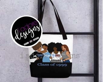 May include: A white tote bag with black straps features a graphic of four women standing together. The women are wearing different outfits and have different hairstyles. The text "Class of 1999" is printed in blue on the bag.