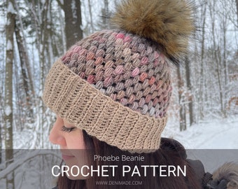 May include: A crochet beanie hat with a brown faux fur pom pom. The beanie is made with a textured stitch and features a color gradient of brown, pink, and white. The beanie is photographed against a snowy background. "Phoebe Beanie CROCHET PATTERN WWW.DENIMADE.COM"