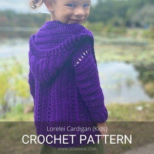 May include: A purple crocheted cardigan with a hood, worn by a child. The cardigan has a lacy pattern and is shown against a blurred background of a pond and trees. The text "Lorelei Cardigan (Kids) CROCHET PATTERN WWW.DENIMADE.COM" is at the bottom of the image.