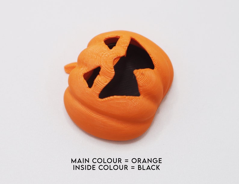 May include: Orange plastic pumpkin with a black face carved into it.