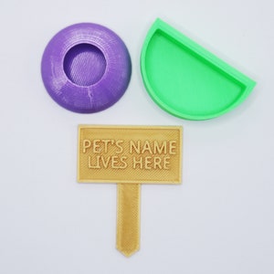 May include: A set of three 3D printed pet accessories in purple, green, and brown. The set includes a food bowl, a water bowl, and a sign that says "PET'S NAME LIVES HERE".