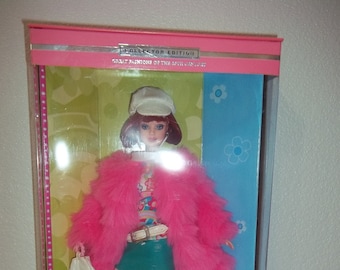 Groovy 60's Barbie Titian Hair by Mattel wearing Go go boots, mini skirt, mod earrings, net stockings, pink fur and psychedelic shirt shirt