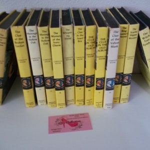 May include: A collection of 16 yellow and black paperback books with titles like "The Clue of the Broken Locket" and "The Witch Tree Symbol".