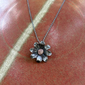 Hand forged iron sunflower pendant with bronze riveted center