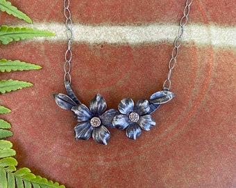 Pair of hand forged iron flower pendant with bronze riveted center on sterling chain