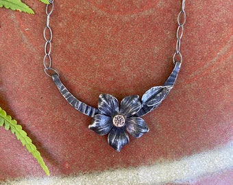 Hand forged iron flower and leaf pendant with bronze riveted center on hammered half moon on sterling chain