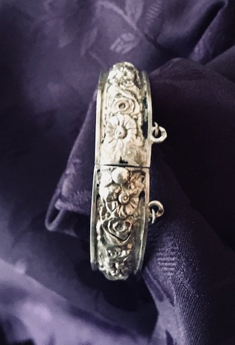 This bangle is very detailed and exquisite. Childs vintage embossed bangle with safety chain rare find