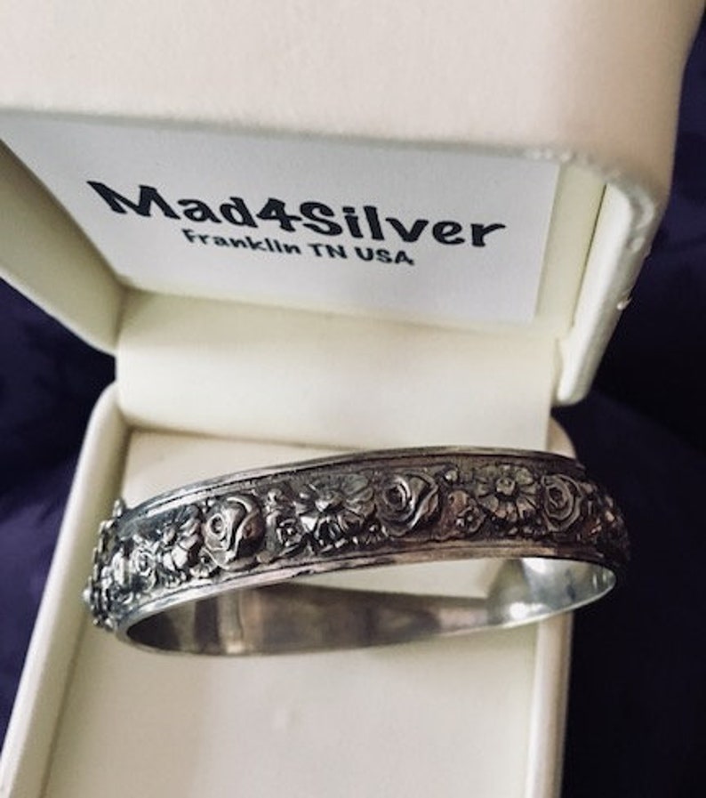 This bangle is very detailed and exquisite. Childs vintage embossed bangle with safety chain rare find