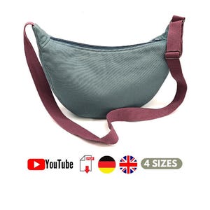 Puede incluir: Un bolso de cintura de color verde azulado con una correa y cremallera burdeos. El bolso tiene forma curva y una correa larga ajustable. La imagen también incluye el logotipo de YouTube, un icono PDF y el texto "4 SIZES".