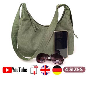 May include: A green canvas shoulder bag with a long strap. The bag is shown with a mobile phone and sunglasses inside. The image also includes the text "YouTube", "PDF", "4 SIZES", and flags for the United Kingdom and Germany.