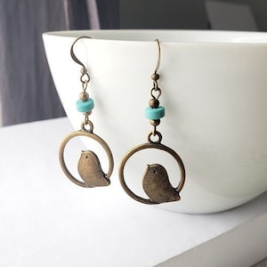 Bird earrings with turquoise bead in antique brass