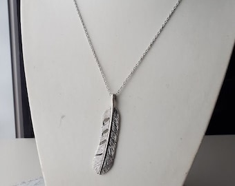 Large feather charm on stainless steel necklace