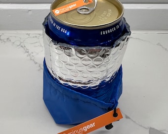 May include: A blue and silver insulated can cooler with a blue drawstring base. The can inside is gold and blue. The cooler has a tag that says "minusgear Minimalist Style".