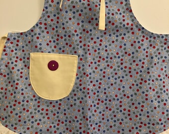 Tea party apron designed for pretend play, baking and crafting. Colorful blue dot fabric.
