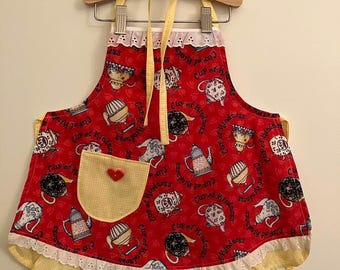 Tea party apron designed for pretend play, baking and crafting. Red teapot fabric.