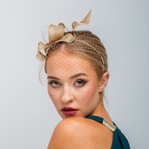Modern fascinator with veiling , small gold fascinator, serpentine shape fascinator, sinamay bow, headpiece, netting gold headpiece