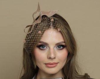 Modern fascinator with spotted veiling , small nude fascinator, serpentine shape fascinator, sinamay bow, headpiece, netting gold headpiece
